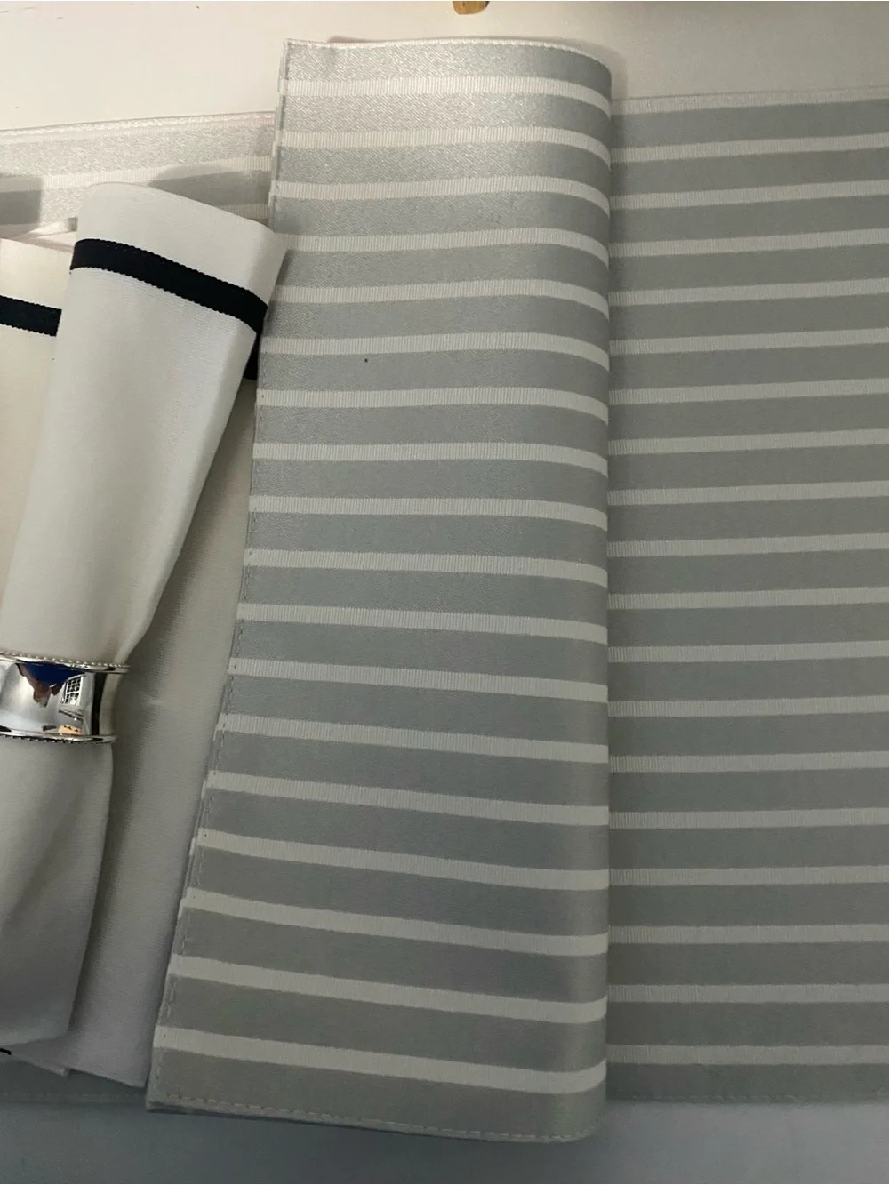 White and Black Trim napkins plus grey and white strip place mats.  Kate Spade.